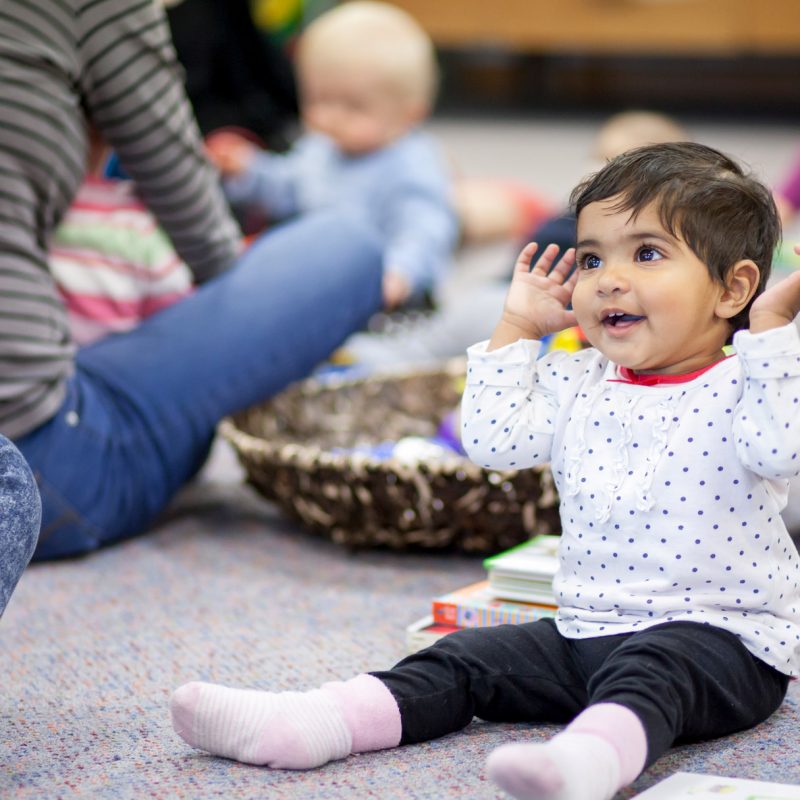 Young child with hands in air